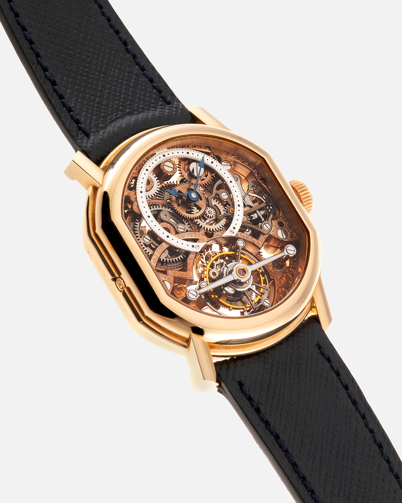 Brand: Daniel Roth Year: 1990’s Model: 2187 Material: 18k Yellow Gold Movement: Cal. DR 307 One-Minute Tourbillon Regulator Case Diameter: 35mm X 38mm Strap: Molequin Navy Blue Textured Calf and18k Yellow Gold Tang Buckle