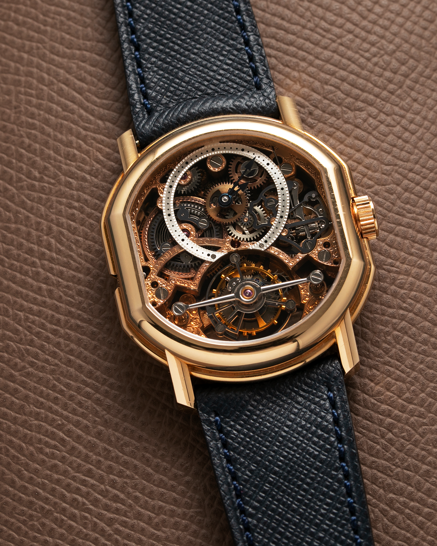 Brand: Daniel Roth Year: 1990’s Model: 2187 Material: 18k Yellow Gold Movement: Cal. DR 307 One-Minute Tourbillon Regulator Case Diameter: 35mm X 38mm Strap: Molequin Navy Blue Textured Calf and18k Yellow Gold Tang Buckle