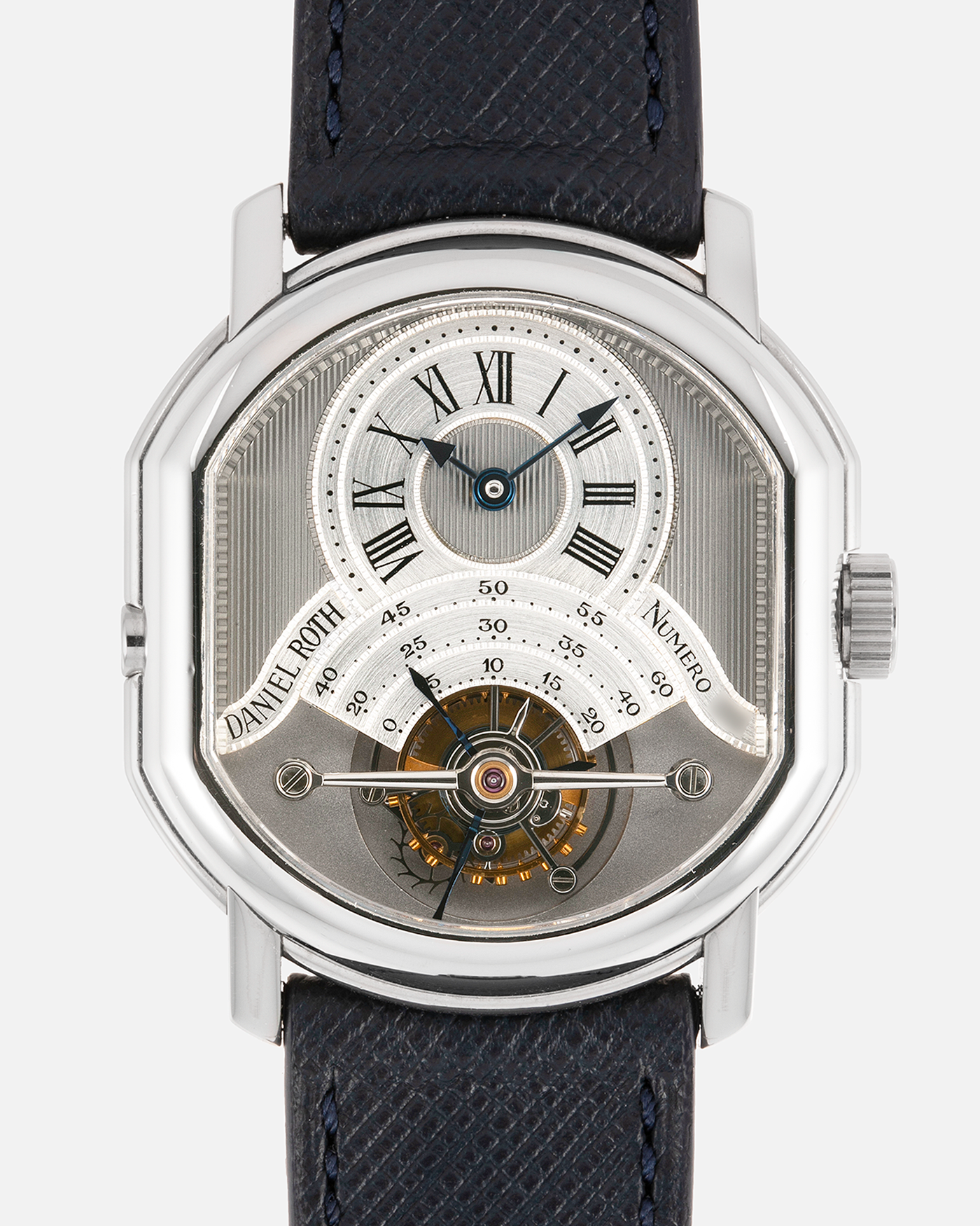 Brand: Daniel Roth Year: 1990’s Model: 2187 Material: Stainless Steel Movement: Cal. DR 307 One-Minute Tourbillon Regulator Case Diameter: 35mm X 38mm Strap: Molequin Navy Blue Textured Calf and Stainless Steel Deployant Clasp