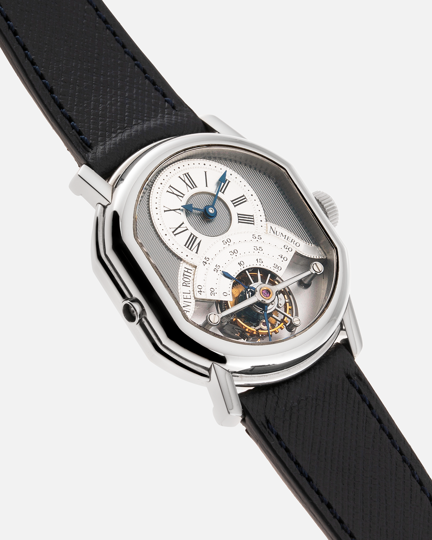 Brand: Daniel Roth Year: 1990’s Model: 2187 Material: Stainless Steel Movement: Cal. DR 307 One-Minute Tourbillon Regulator Case Diameter: 35mm X 38mm Strap: Molequin Navy Blue Textured Calf and Stainless Steel Deployant Clasp