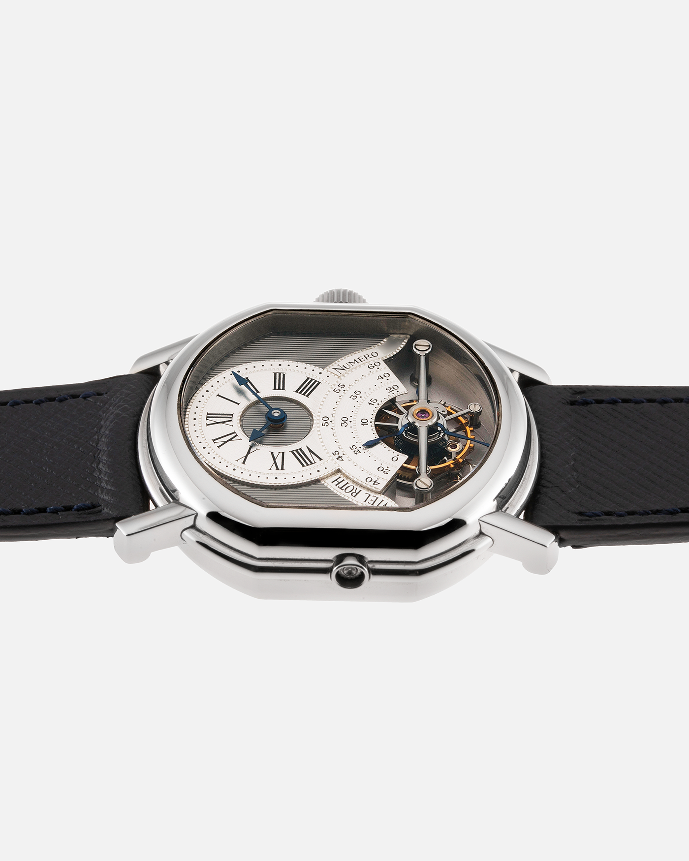Brand: Daniel Roth Year: 1990’s Model: 2187 Material: Stainless Steel Movement: Cal. DR 307 One-Minute Tourbillon Regulator Case Diameter: 35mm X 38mm Strap: Molequin Navy Blue Textured Calf and Stainless Steel Deployant Clasp