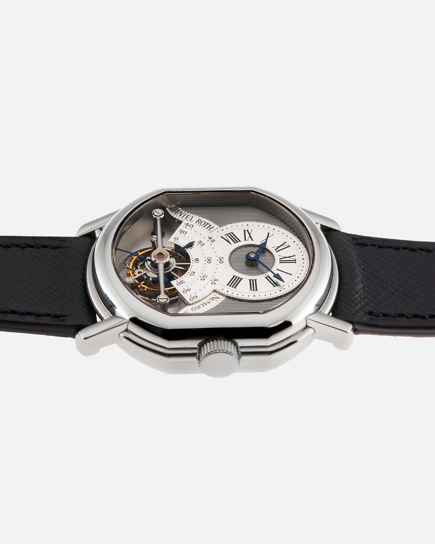 Brand: Daniel Roth Year: 1990’s Model: 2187 Material: Stainless Steel Movement: Cal. DR 307 One-Minute Tourbillon Regulator Case Diameter: 35mm X 38mm Strap: Molequin Navy Blue Textured Calf and Stainless Steel Deployant Clasp