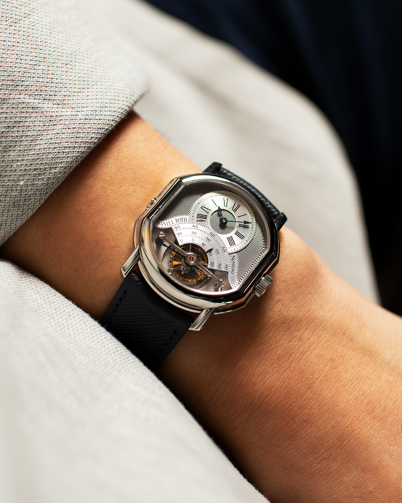 Brand: Daniel Roth Year: 1990’s Model: 2187 Material: Stainless Steel Movement: Cal. DR 307 One-Minute Tourbillon Regulator Case Diameter: 35mm X 38mm Strap: Molequin Navy Blue Textured Calf and Stainless Steel Deployant Clasp