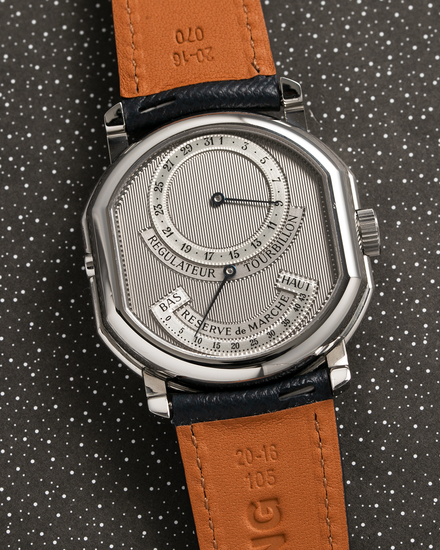 Brand: Daniel Roth Year: 1990’s Model: 2187 Material: Stainless Steel Movement: Cal. DR 307 One-Minute Tourbillon Regulator Case Diameter: 35mm X 38mm Strap: Molequin Navy Blue Textured Calf and Stainless Steel Deployant Clasp