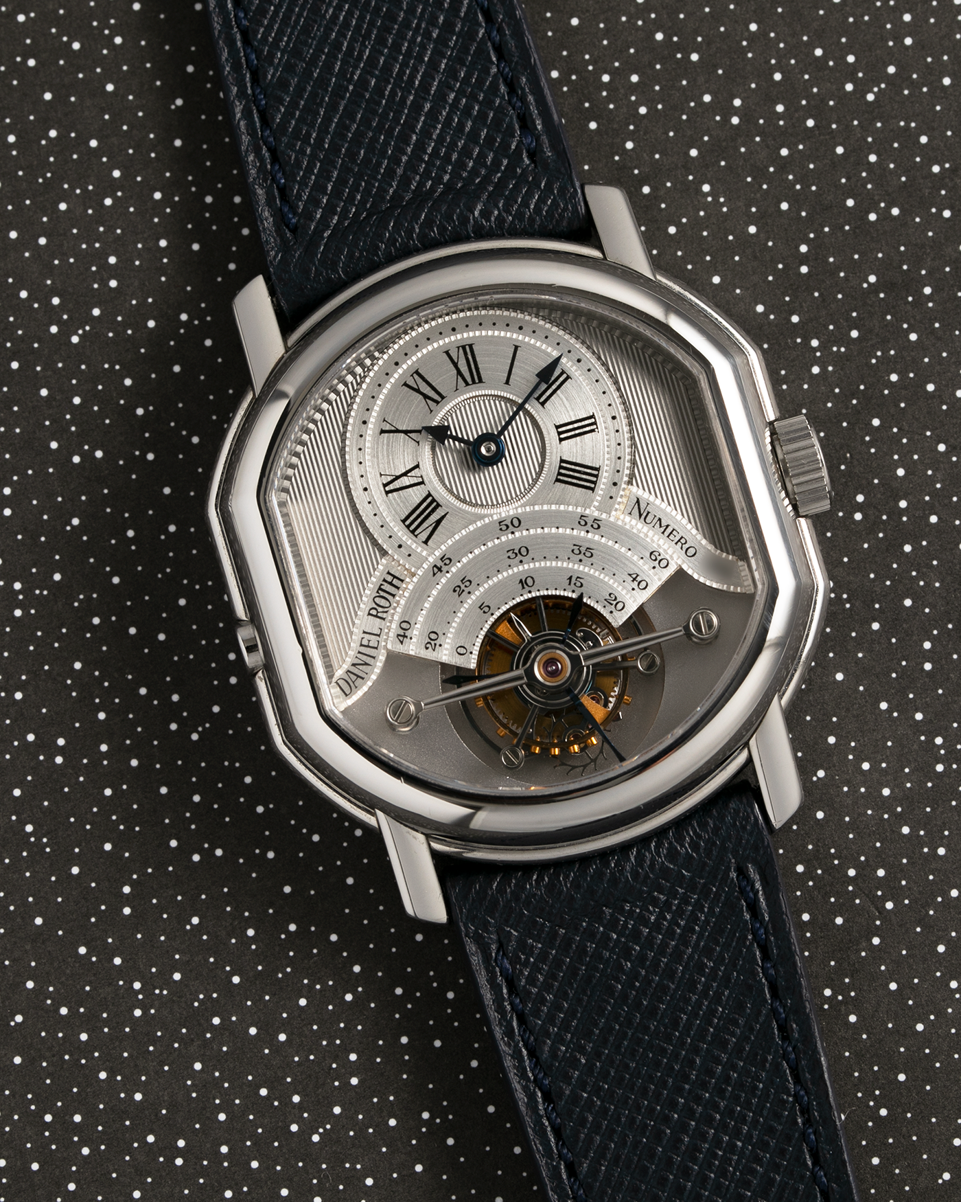 Brand: Daniel Roth Year: 1990’s Model: 2187 Material: Stainless Steel Movement: Cal. DR 307 One-Minute Tourbillon Regulator Case Diameter: 35mm X 38mm Strap: Molequin Navy Blue Textured Calf and Stainless Steel Deployant Clasp