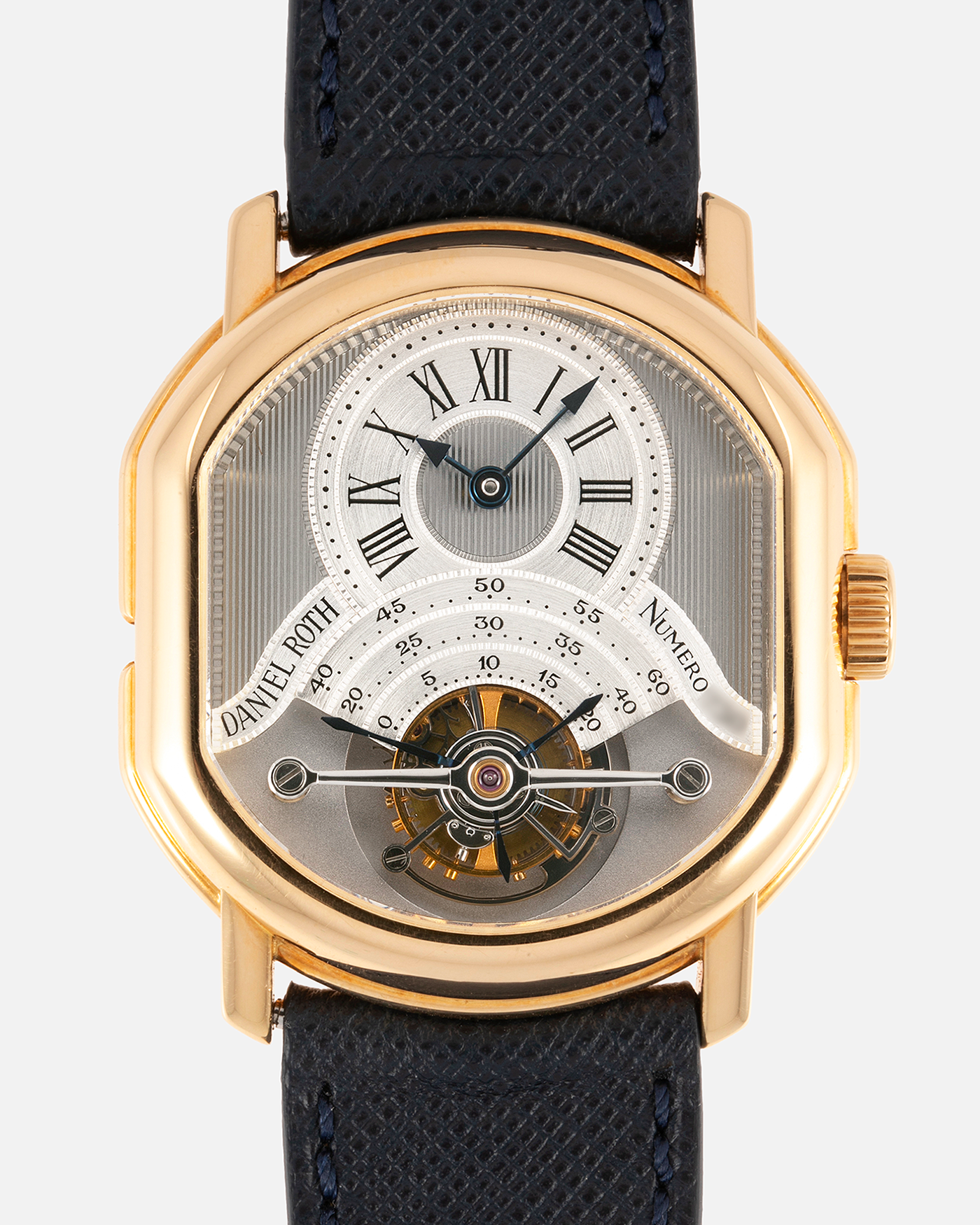 Brand: Daniel Roth Year: 1990’s Model: 2187 Material: 18k Yellow Gold Movement: Cal. DR 307 One-Minute Tourbillon Regulator Case Diameter: 35mm X 38mm Strap: Molequin Navy Blue Textured Calf