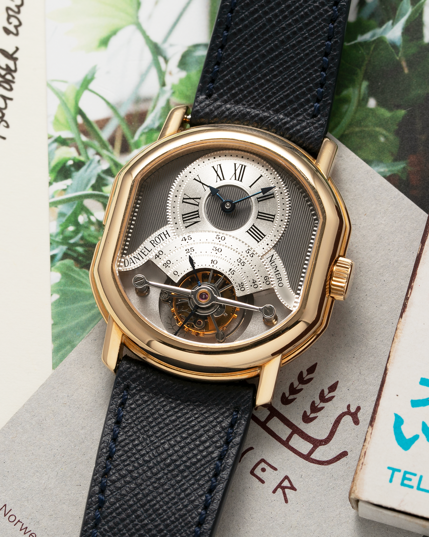 Brand: Daniel Roth Year: 1990’s Model: 2187 Material: 18k Yellow Gold Movement: Cal. DR 307 One-Minute Tourbillon Regulator Case Diameter: 35mm X 38mm Strap: Molequin Navy Blue Textured Calf