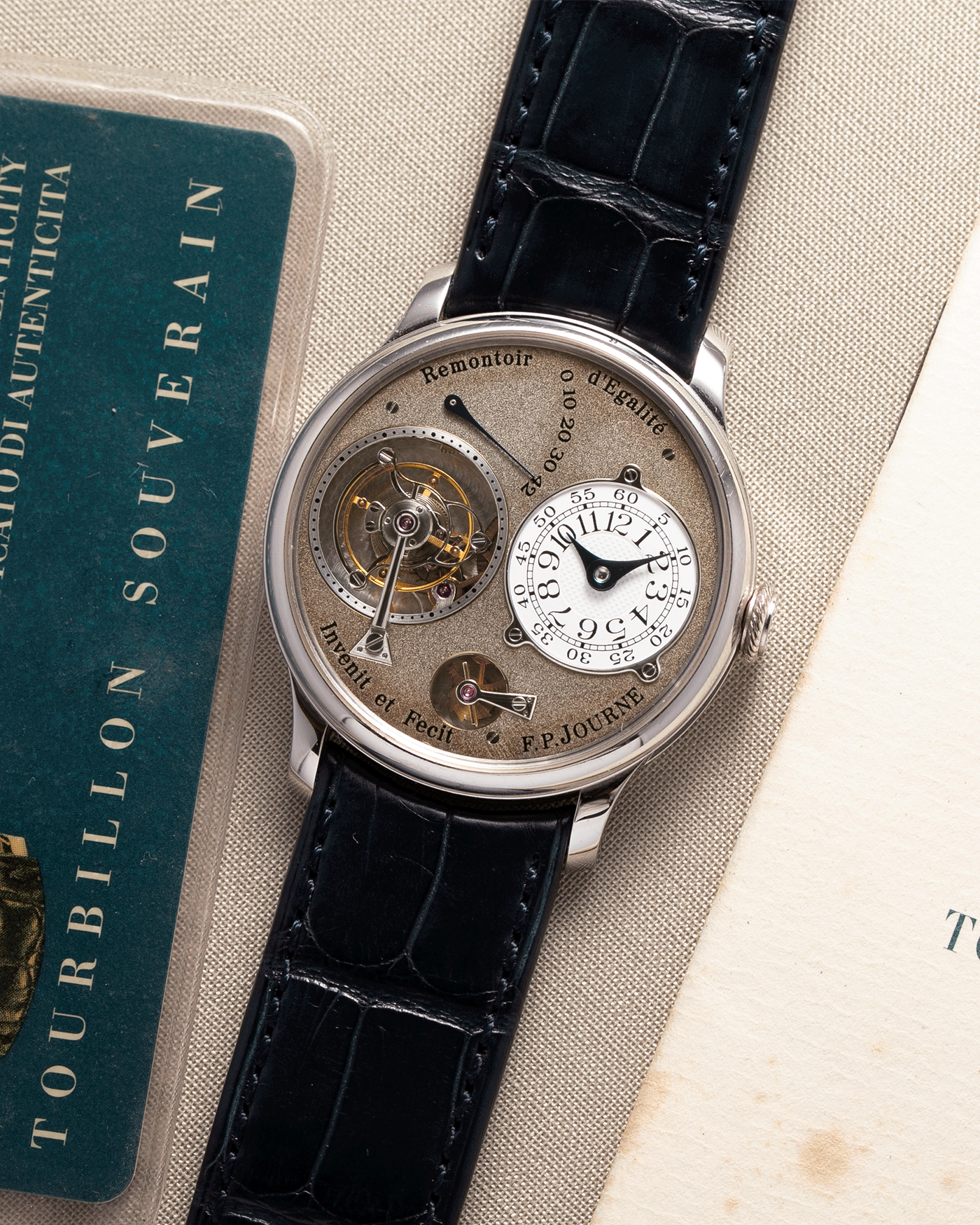 Brand: F.P. Journe Year: 2003 Model: Tourbillon Souverain Material: Platinum Movement: FPJ Caliber 1498 (One second remontoir d’egalite) Case Diameter: 38mm Bracelet/Strap: F.P. Journe Navy Blue Alligator and Platinum Signed Tang Buckle