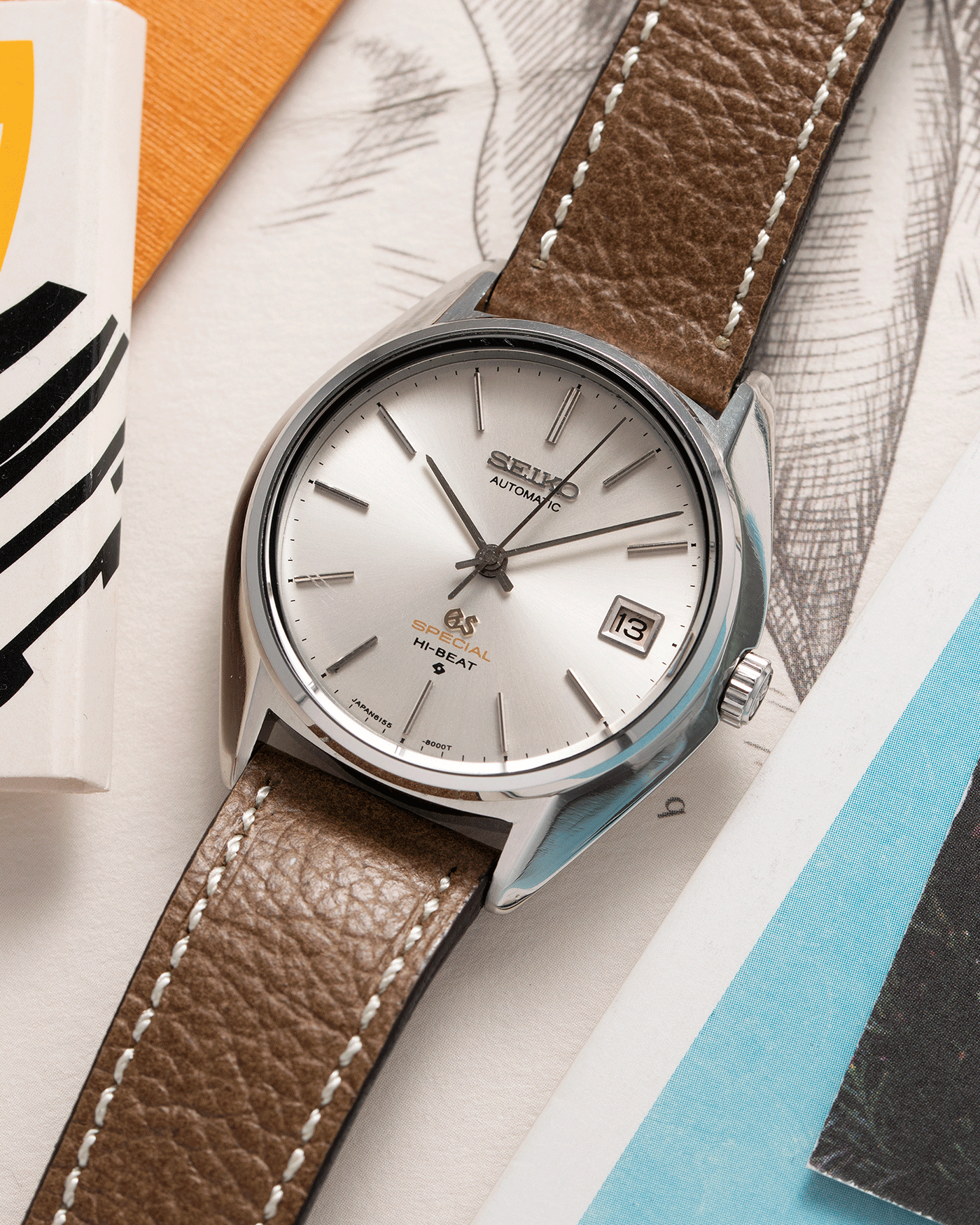 Brand: Grand Seiko Year: Circa 1970’s Reference Number: 6155-8000 Material: Stainless Steel Movement: Cal 6155 Case Diameter: 36.5mm Lug Width: 18mm Bracelet/Strap: Unbranded Chestnut Brown Textured Leather