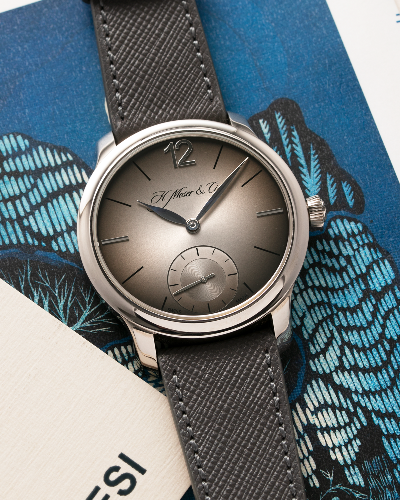 Brand: H.Moser & Cie Year: 2013 Model: Mayu  Material: Palladium Movement: Cal. HMC321.503 Case Diameter: 39mm Bracelet/Strap: Molequin Grey Textured Calf and H. Moser & Cie Black Alligator Strap with Palladium Tang Buckle