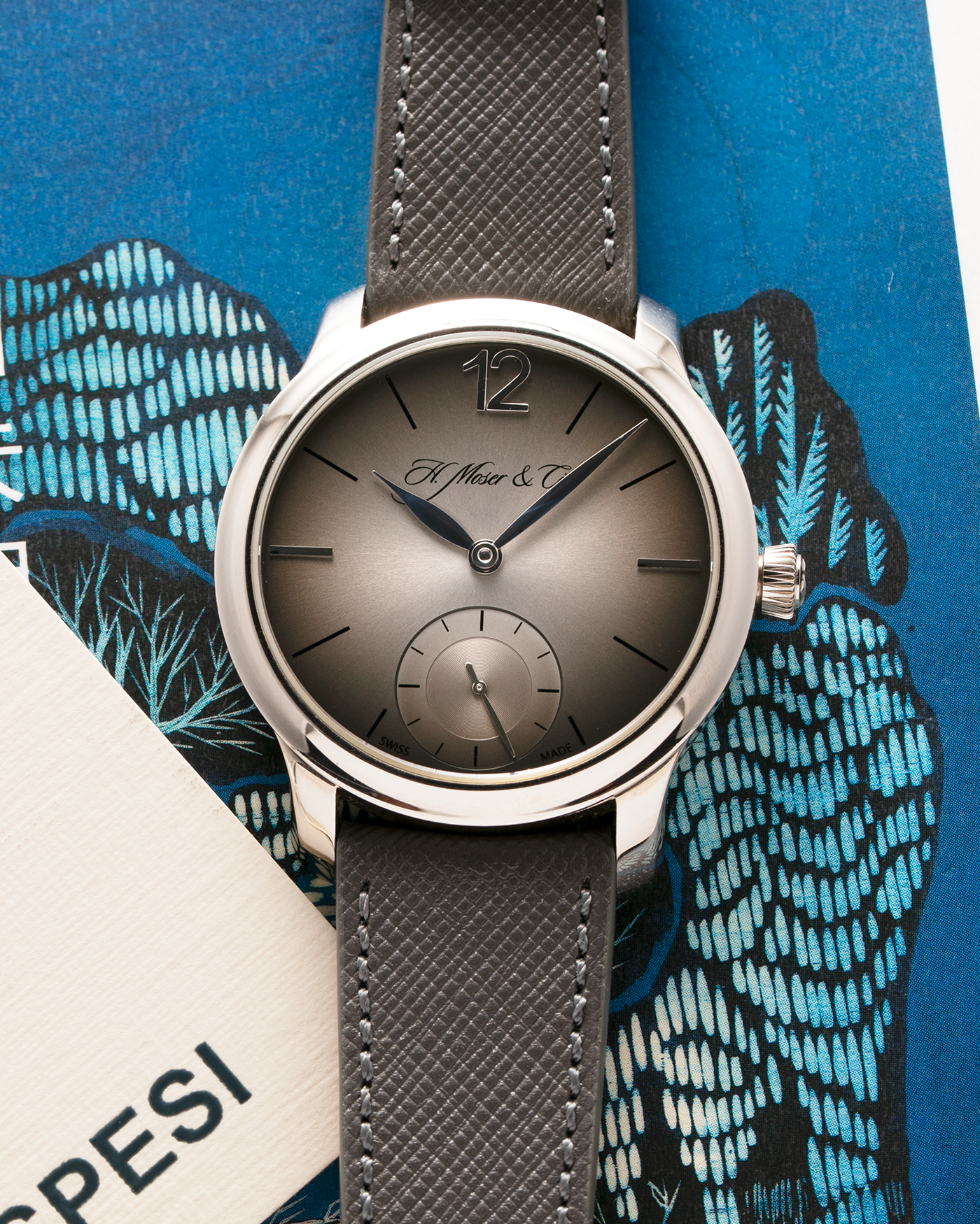 Brand: H.Moser & Cie Year: 2013 Model: Mayu  Material: Palladium Movement: Cal. HMC321.503 Case Diameter: 39mm Bracelet/Strap: Molequin Grey Textured Calf and H. Moser & Cie Black Alligator Strap with Palladium Tang Buckle