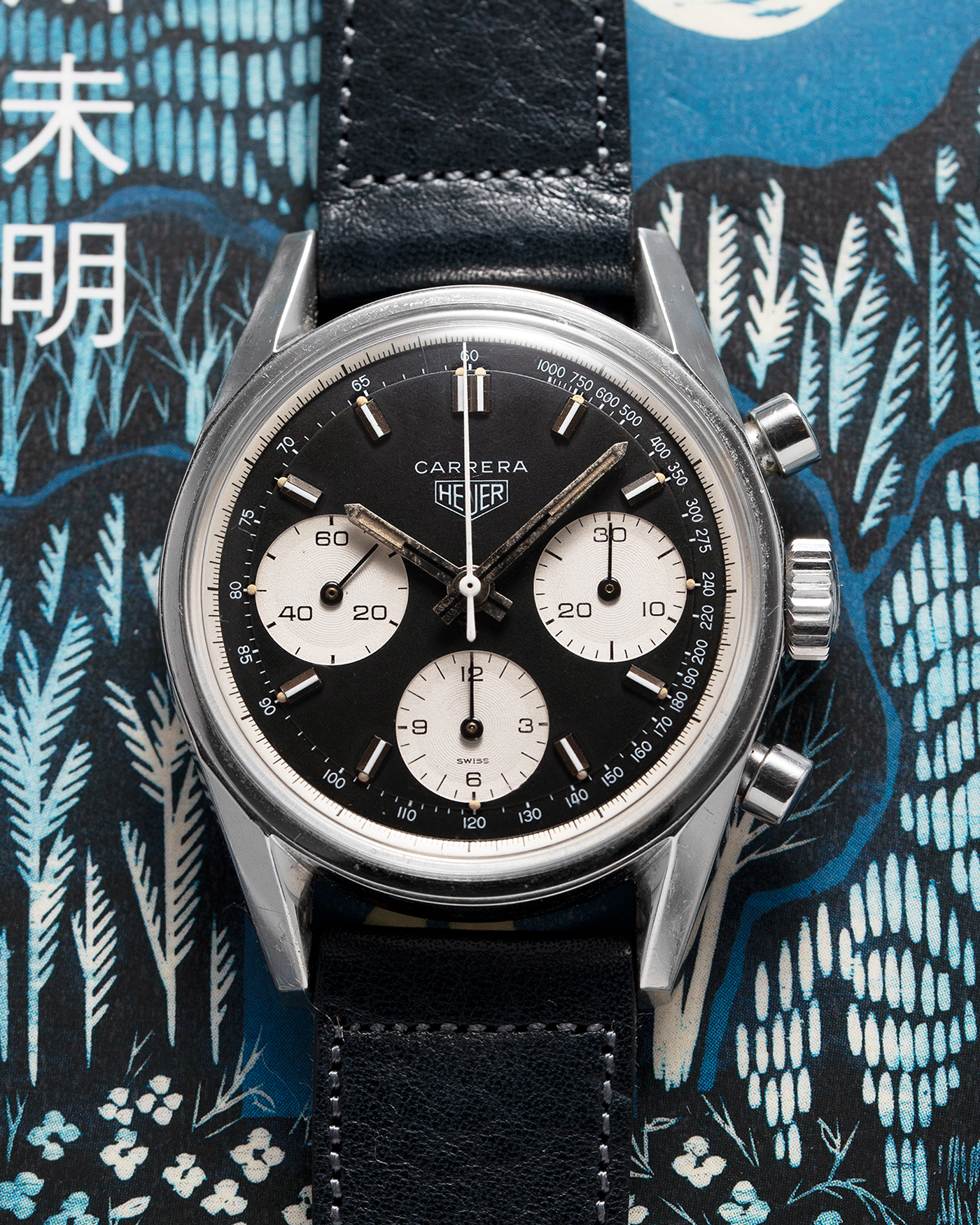 Brand: Heuer Year: 1960’s Model: Carrera Reference Number: 2447NST Material: Stainless Steel Movement: Valjoux 72 Case Diameter: 36mm Lug Width: 18mm Bracelet/Strap: Accurate Form Navy Blue Calf