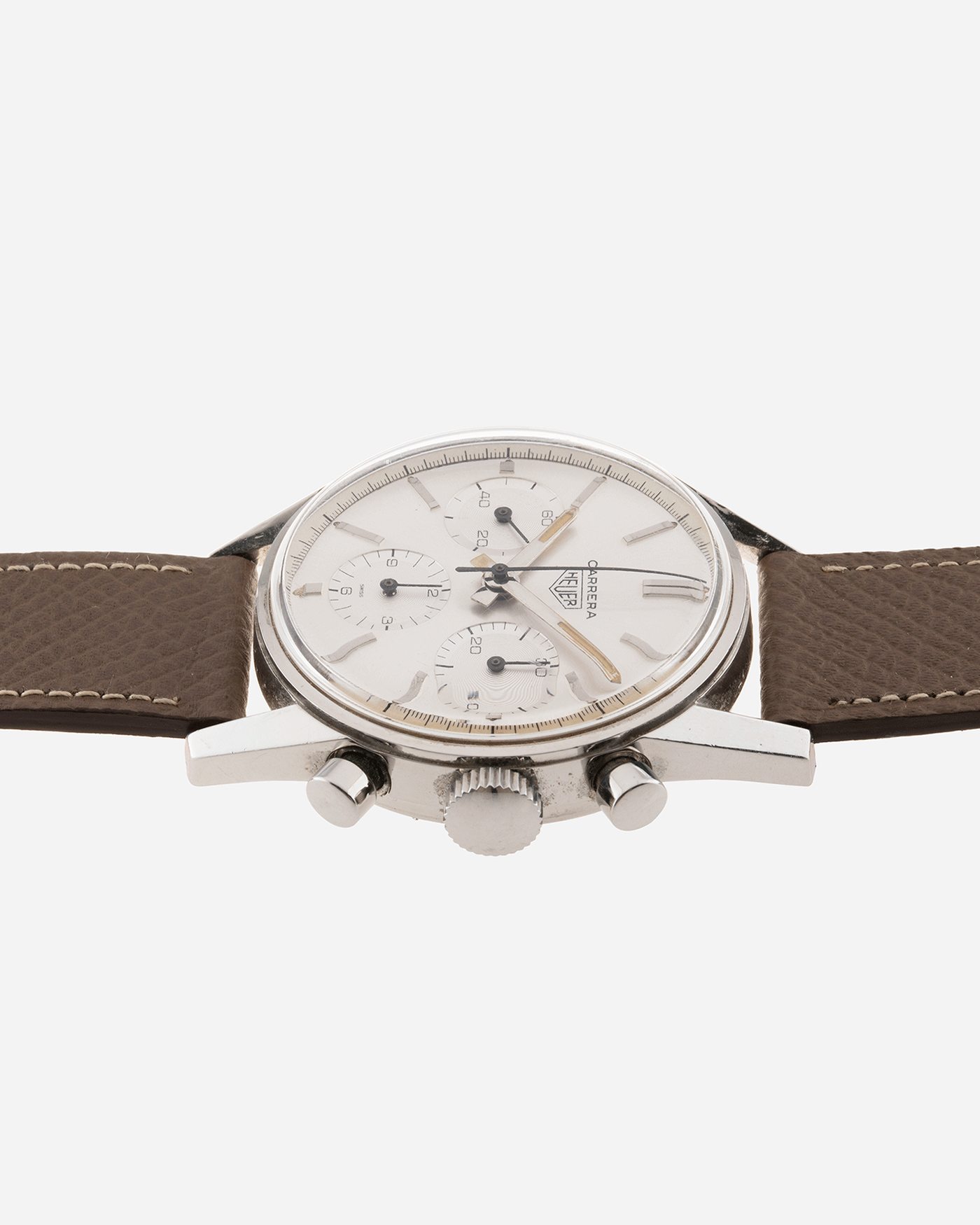 Brand: Heuer Year: 1960’s Model: Carrera Reference Number: 2447S Material: Stainless Steel Movement: Valjoux 72 Case Diameter: 36mm Lug Width: 18mm Bracelet/Strap: Nostime Grained Taupe