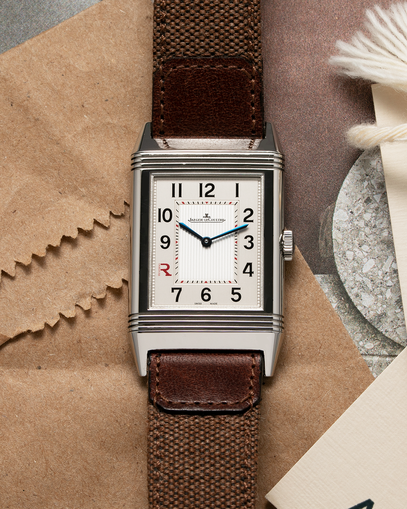 Brand: Jaeger LeCoultre Year: 2011 Model: Grande Reverso Ultra Thin Edizione Speciale Italica Ref 277.8.62 Material: Stainless Steel Movement: JLC Cal. 822, Manual-Wind Case Diameter: 46mm x 27mm Bracelet/Strap: Jaeger LeCoultre Case Fagliomo Brown Canvas Strap with Signed Tang Buckle