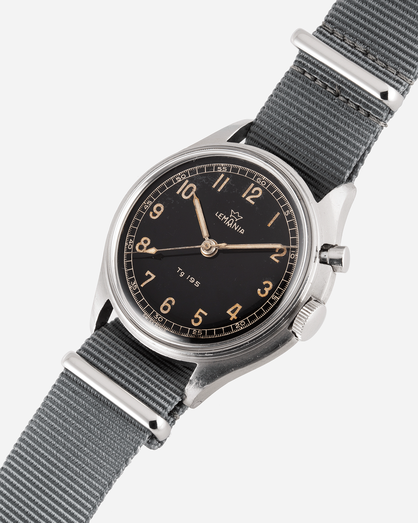 Brand: Lemania Year: 1957 Model: TG 195 Material: Stainless Steel Movement: Cal. 2225 Case Diameter: 40mm Lug Width: 20mm Bracelet/Strap: Grey NATO Strap