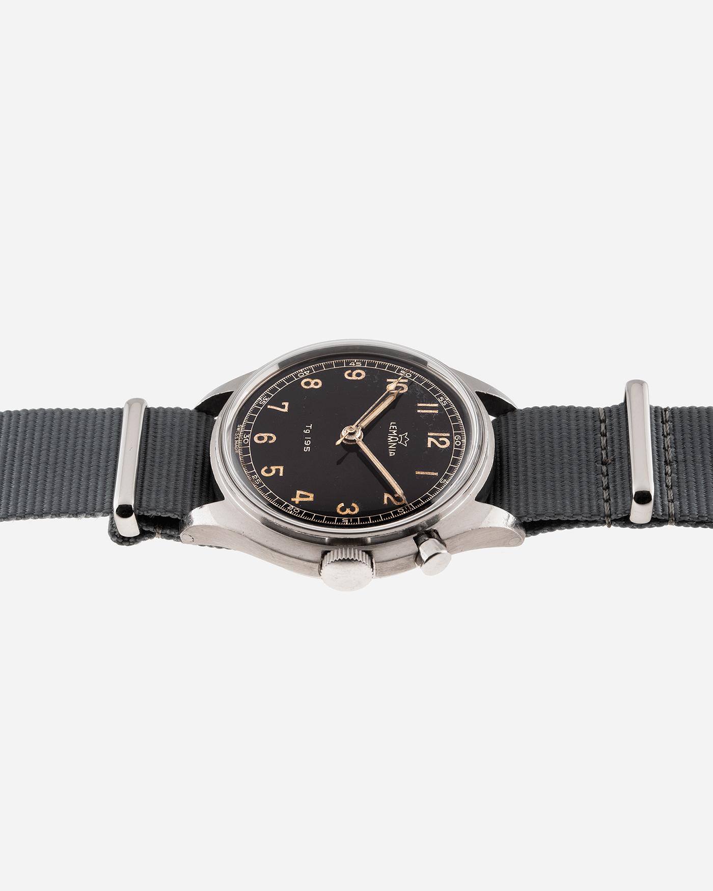 Brand: Lemania Year: 1957 Model: TG 195 Material: Stainless Steel Movement: Cal. 2225 Case Diameter: 40mm Lug Width: 20mm Bracelet/Strap: Grey NATO Strap