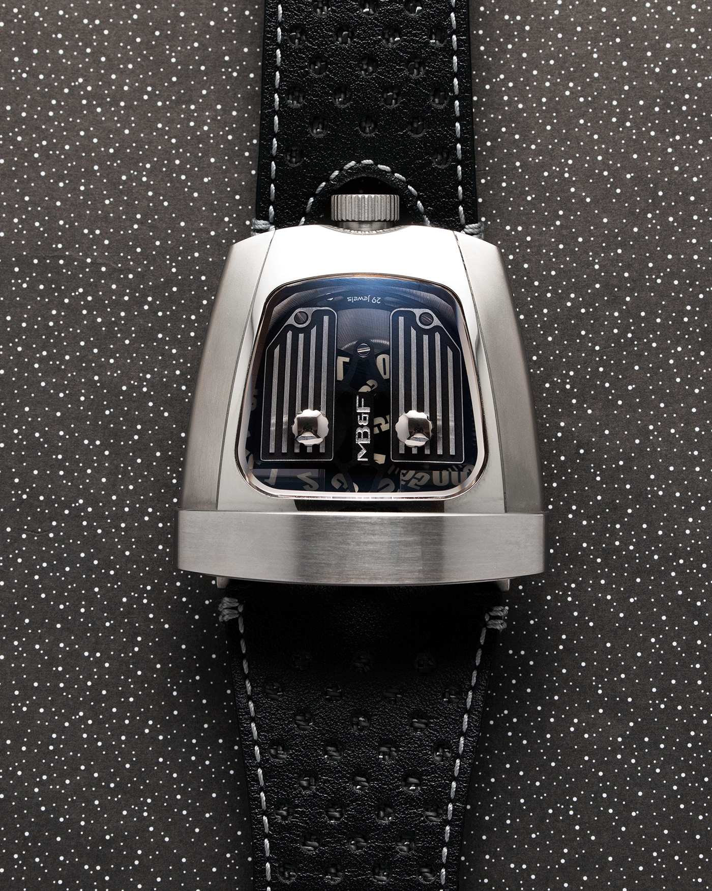 Brand: MB&F Year: 2018 Model: HMX Black Lotus 10th Anniversary Material: Stainless Steel and Titanium Movement: Selitta Based Self Winding Movement Case Diameter: 46.8 x 44.3 x 20.7 mm Bracelet/Strap: MB&F Black Leather Strap and Tang Buckle