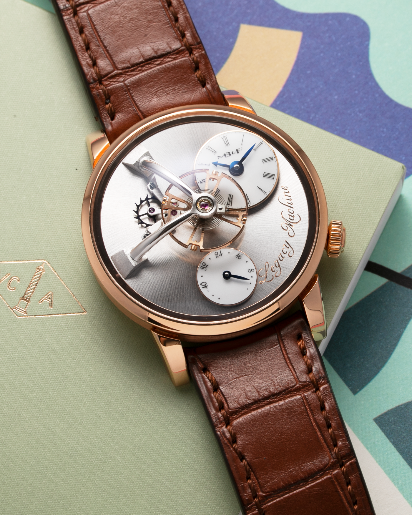 Brand: MB&F Year: 2021 Model: LM101  Material: Rose Gold Movement: In-House MB&F Caliber in collaboration with Kari Voutilainen Case Diameter: 40mm Bracelet/Strap: MB&F Brown Alligator Strap and 18k Rose Gold Tang Buckle