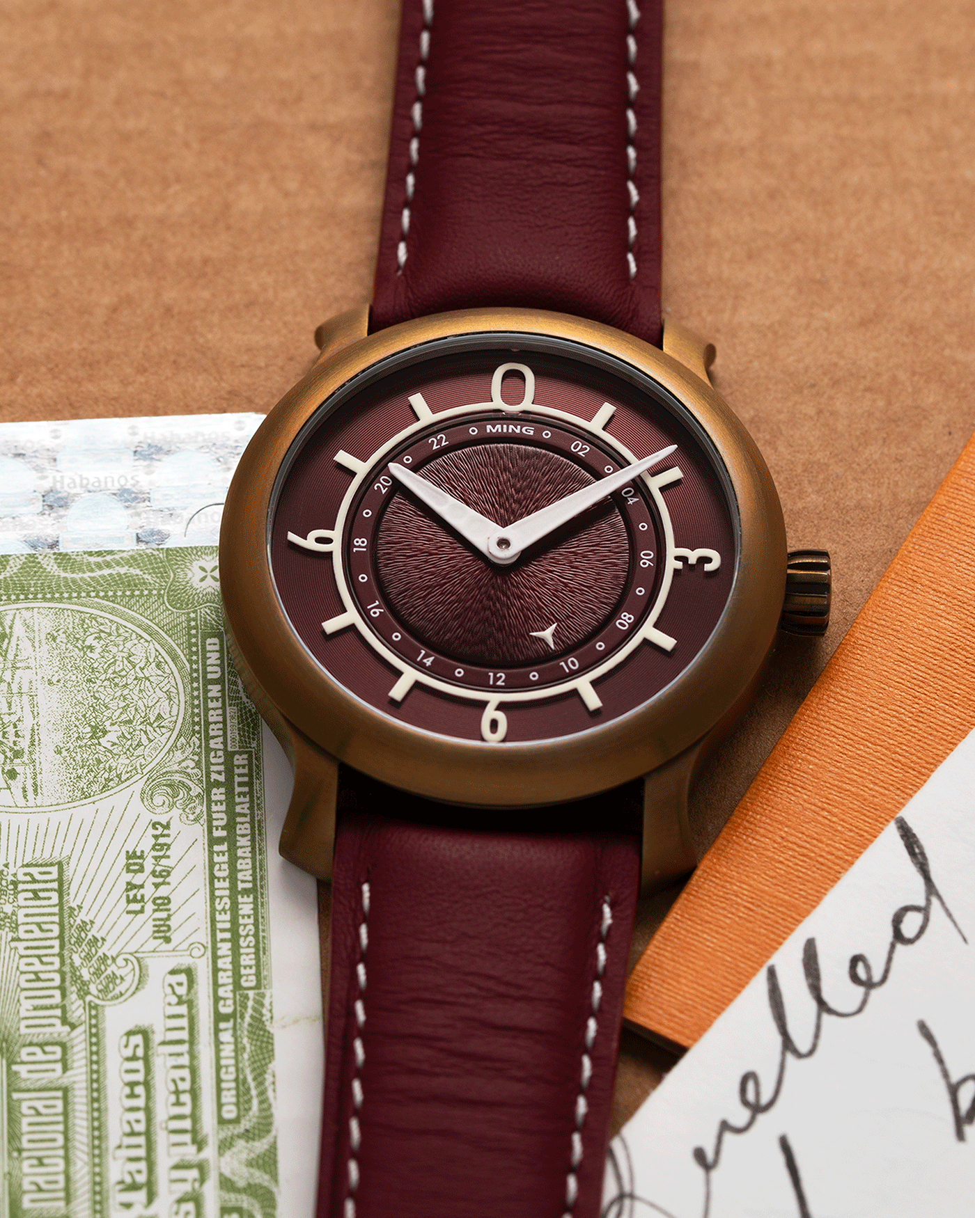 Brand: Ming Year: 2018 Model: 17.03 BB Edition Material: Anodised Grade 2 Titanium Movement: Self-Winding Sellita SW 330-1 Case Diameter: 38mm Strap: Ming Burgundy Smooth Calf by Jean Rousseau Paris and Matching Annodised Grade 2 Titanium Tang Buckle