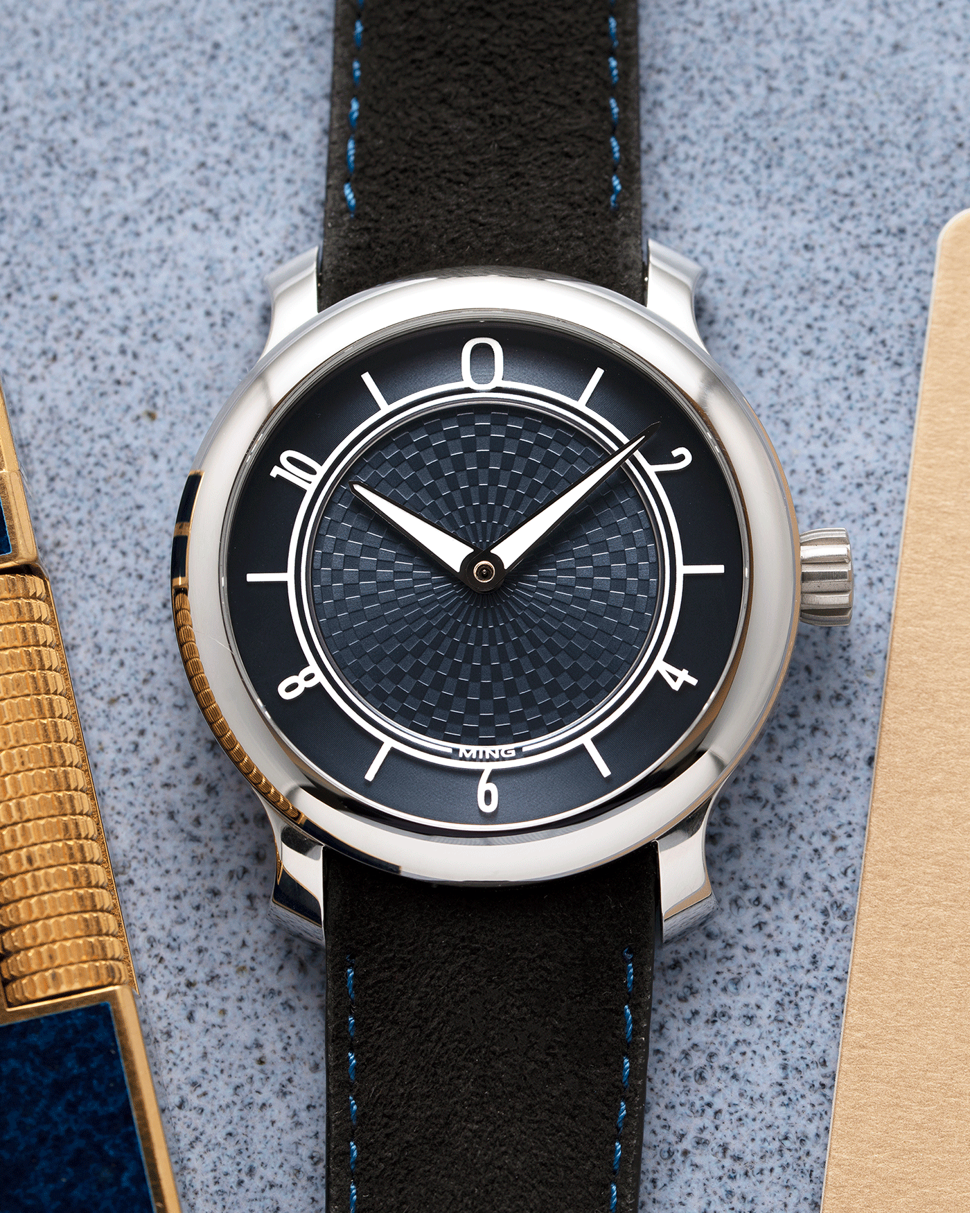 Brand: Ming Year: 2019 Model: 17.06 Material: Stainless Steel Movement: Heavily Modified ETA 2824-2 Case Diameter: 38mm Strap: Jean Rousseau Black Suede with Blue Stitching for MING