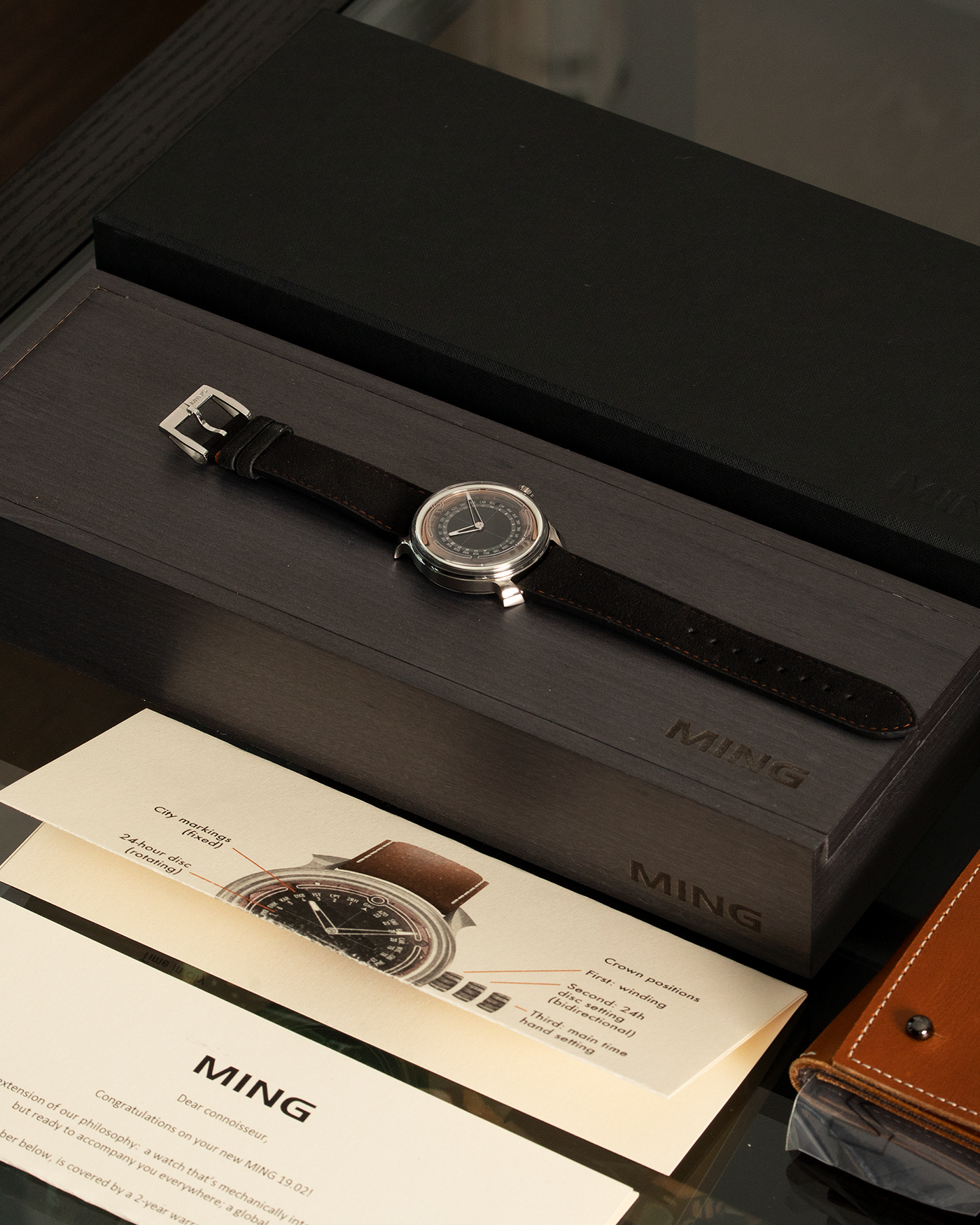 Brand: Ming Year: 2020 Model: 19.02 World Time Material: Grade 5 Titanium Movement: Schwarz-Etienne for MING Cal. ASE 220.1 Case Diameter: 39mm Strap: Jean Rousseau X Ming Black Suede and Stainless Steel Tang Buckle