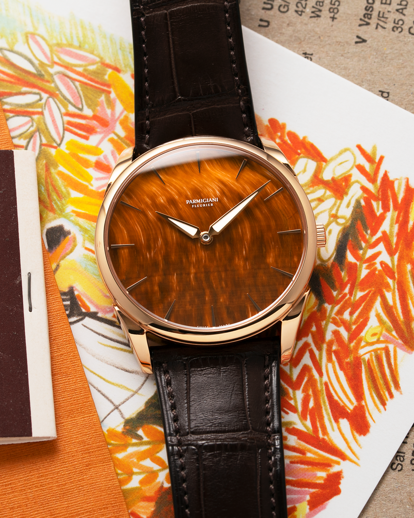 Brand: Parmigiani Fleurier Year: 2022 Model: Tonda 1950 Pisa Edition Tiger Eye Material: 18k Rose Gold Movement: In-House PF 701 Micro Rotor Case Diameter: 39mm Strap: Parmigiani Dark Brown Alligator with 18k Rose Gold Tang Buckle