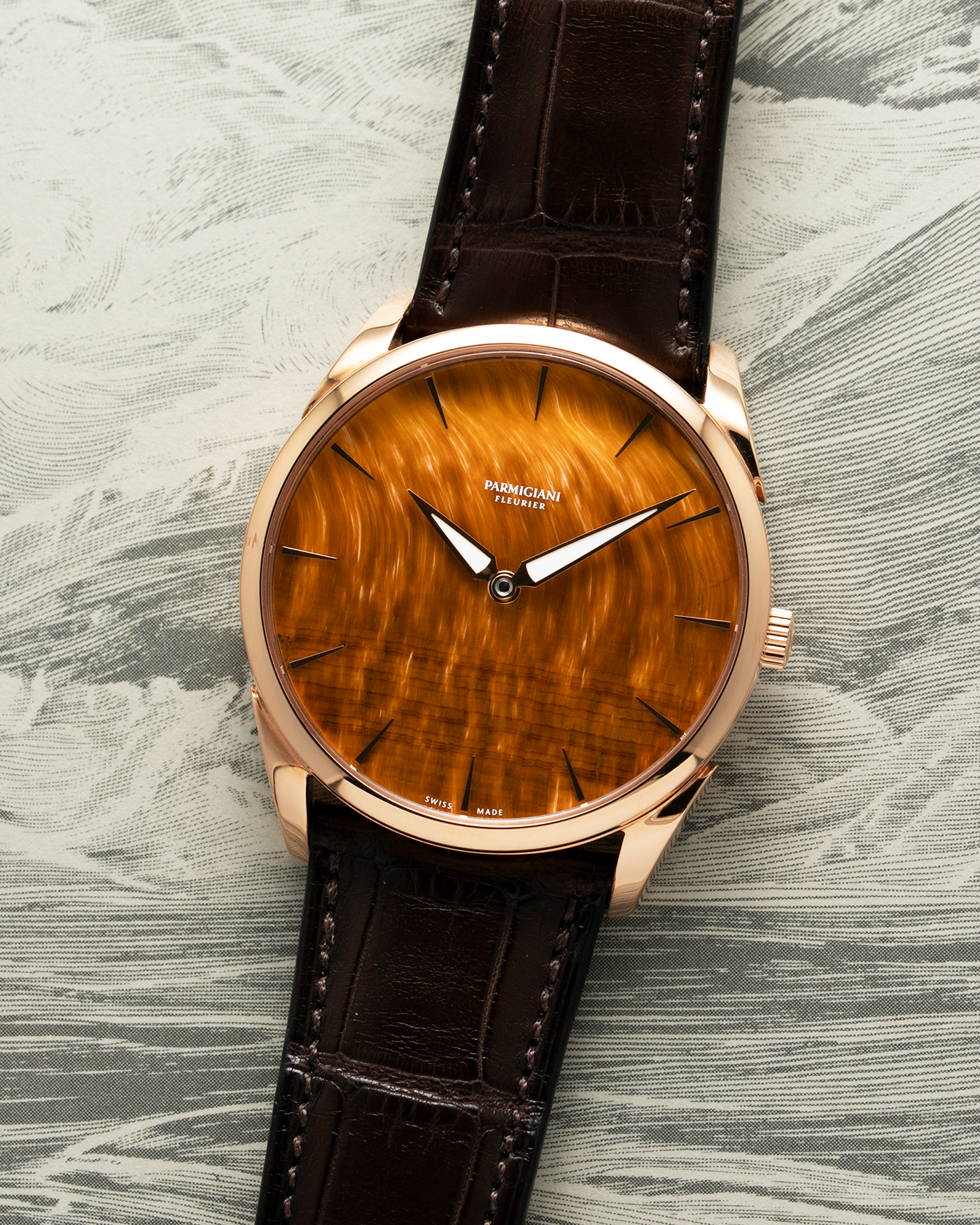 Brand: Parmigiani Fleurier Year: 2022 Model: Tonda 1950 Pisa Edition Tiger Eye Material: 18k Rose Gold Movement: In-House PF 701 Micro Rotor Case Diameter: 39mm Strap: Parmigiani Dark Brown Alligator with 18k Rose Gold Tang Buckle