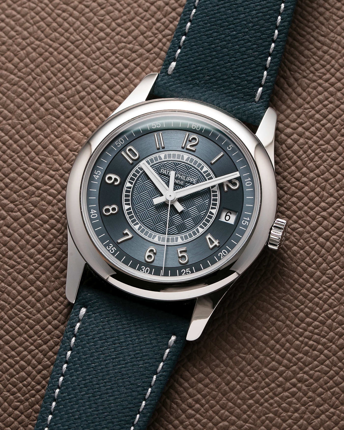 Brand: Patek Philippe Year: 2019 Model: Ref. 6007A Calatrava Limited Edition Material: Stainless Steel Movement: Cal. 324 SC (Seconde Central), Self–Winding Case Diameter: 40mm Bracelet/Strap: Patek Philippe Grey-Blue Calfskin Leather Strap with Embossed Fabric Pattern, and Signed Tang Buckle