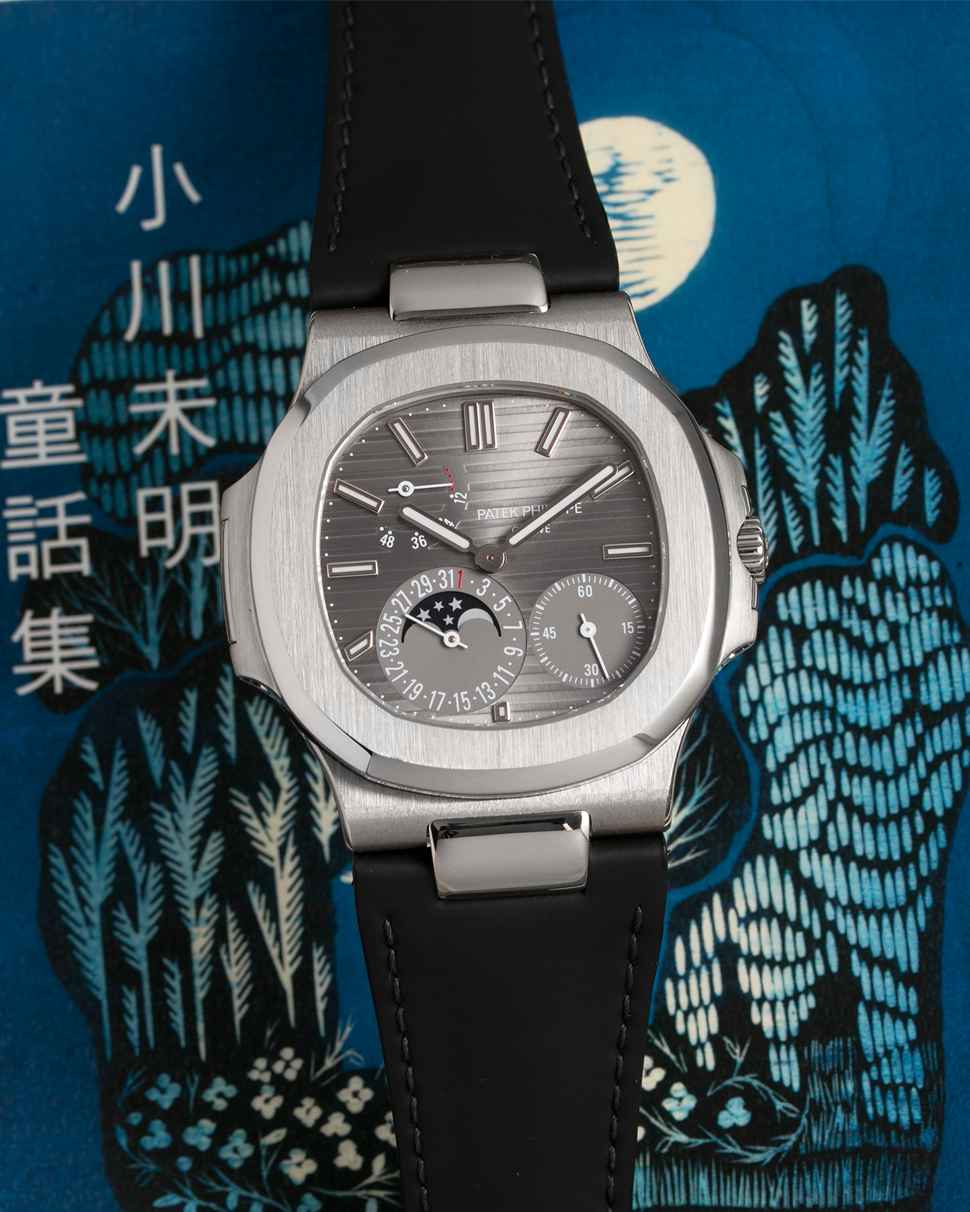 Brand: Patek Philippe Year: 2013 Model: Nautilus Reference Number: 5712G Material:18k White Gold Movement: Cal. 240 PS IRM C LU Case Diameter: 40mm Bracelet: Patek Philippe Grey Leather Strap with 18k White Gold Nautilus Deployant