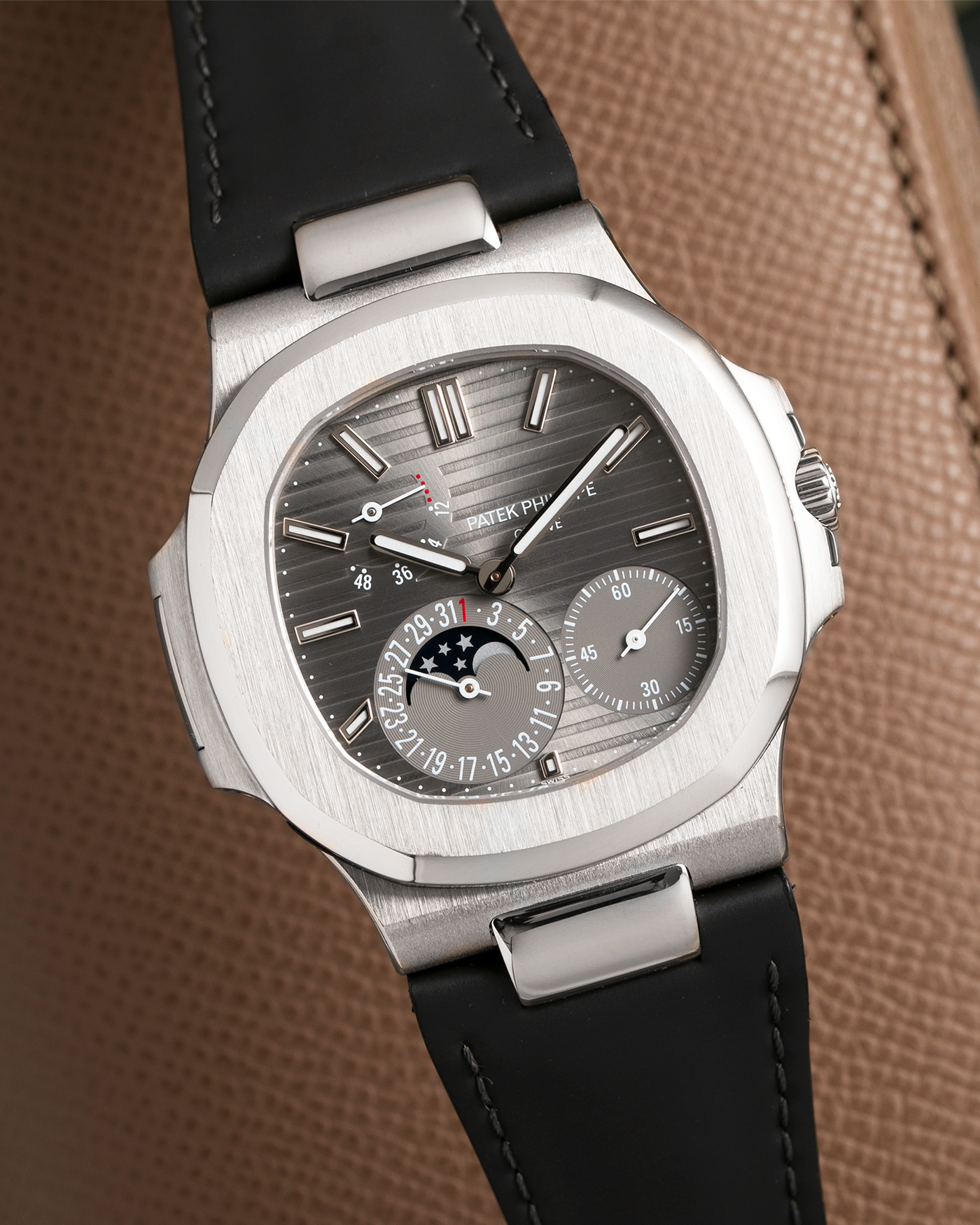 Brand: Patek Philippe Year: 2013 Model: Nautilus Reference Number: 5712G Material:18k White Gold Movement: Cal. 240 PS IRM C LU Case Diameter: 40mm Bracelet: Patek Philippe Grey Leather Strap with 18k White Gold Nautilus Deployant