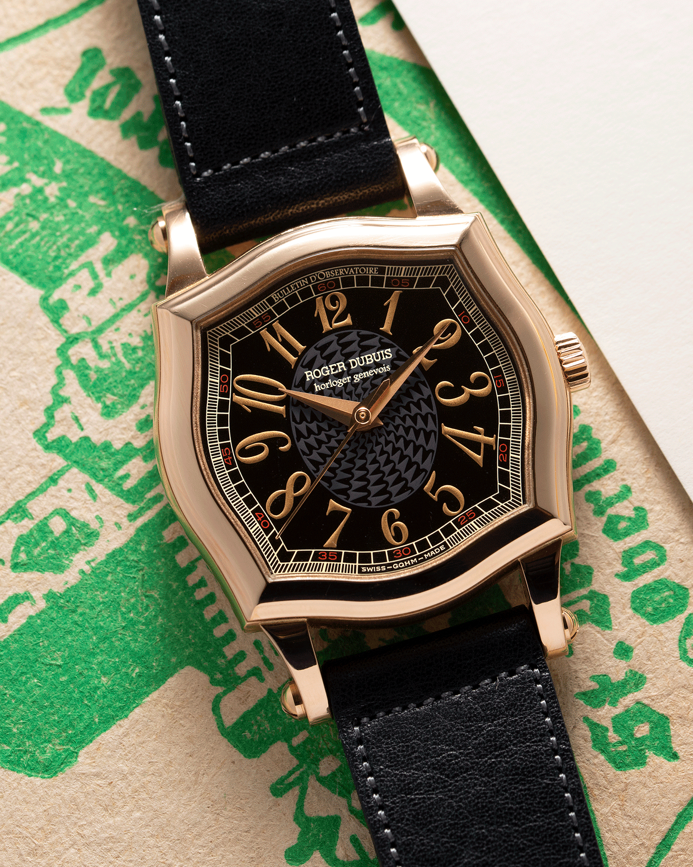 Brand: Roger Dubuis Year: 1998 Model: Sympathie 34 Material: 18k Rose Gold Movement: Cal RD 57 Case Diameter: 34mm Strap: Navy Blue Accurate Form Japanese Calf Leather and 18k Rose Gold Roger Dubuis Tang Buckle