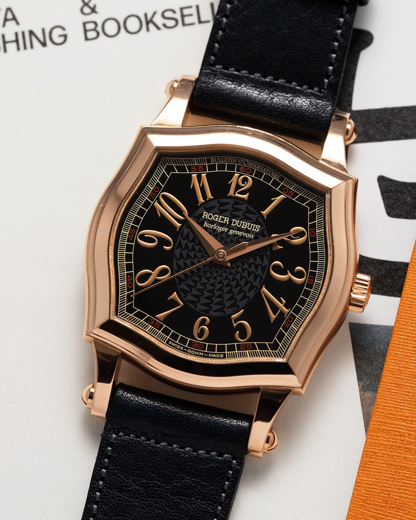 Brand: Roger Dubuis Year: 1998 Model: Sympathie 34 Material: 18k Rose Gold Movement: Cal RD 57 Case Diameter: 34mm Strap: Navy Blue Accurate Form Japanese Calf Leather and 18k Rose Gold Roger Dubuis Tang Buckle