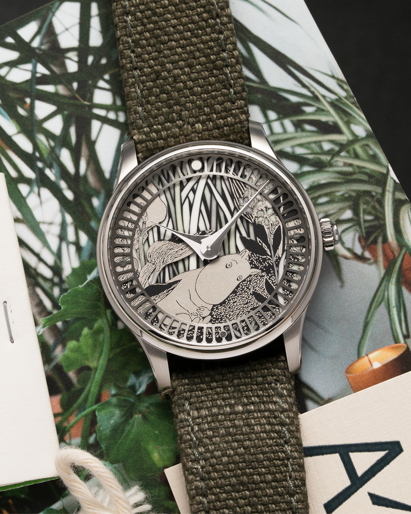 Brand: Sarpaneva S.U.F. Year: 2020 Model: Moomin Material: Stainless Steel Movement: Soprod A10 Case Diameter: 38.7mm Bracelet/Strap: Sarpaneva S.U.F. Green Textile Strap
