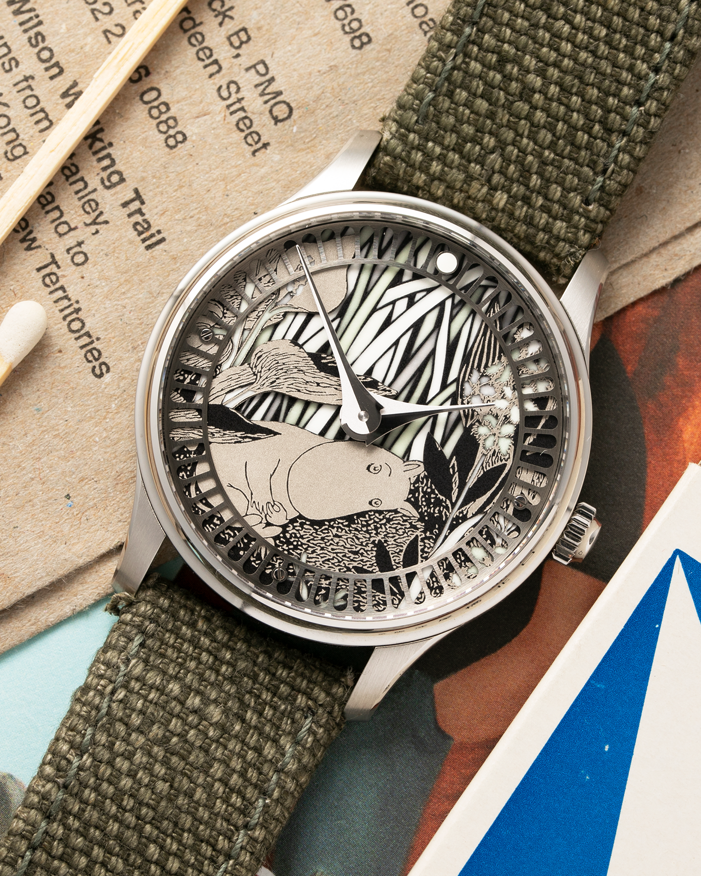 Brand: Sarpaneva S.U.F. Year: 2020 Model: Moomin Material: Stainless Steel Movement: Soprod A10 Case Diameter: 38.7mm Bracelet/Strap: Sarpaneva S.U.F. Green Textile Strap