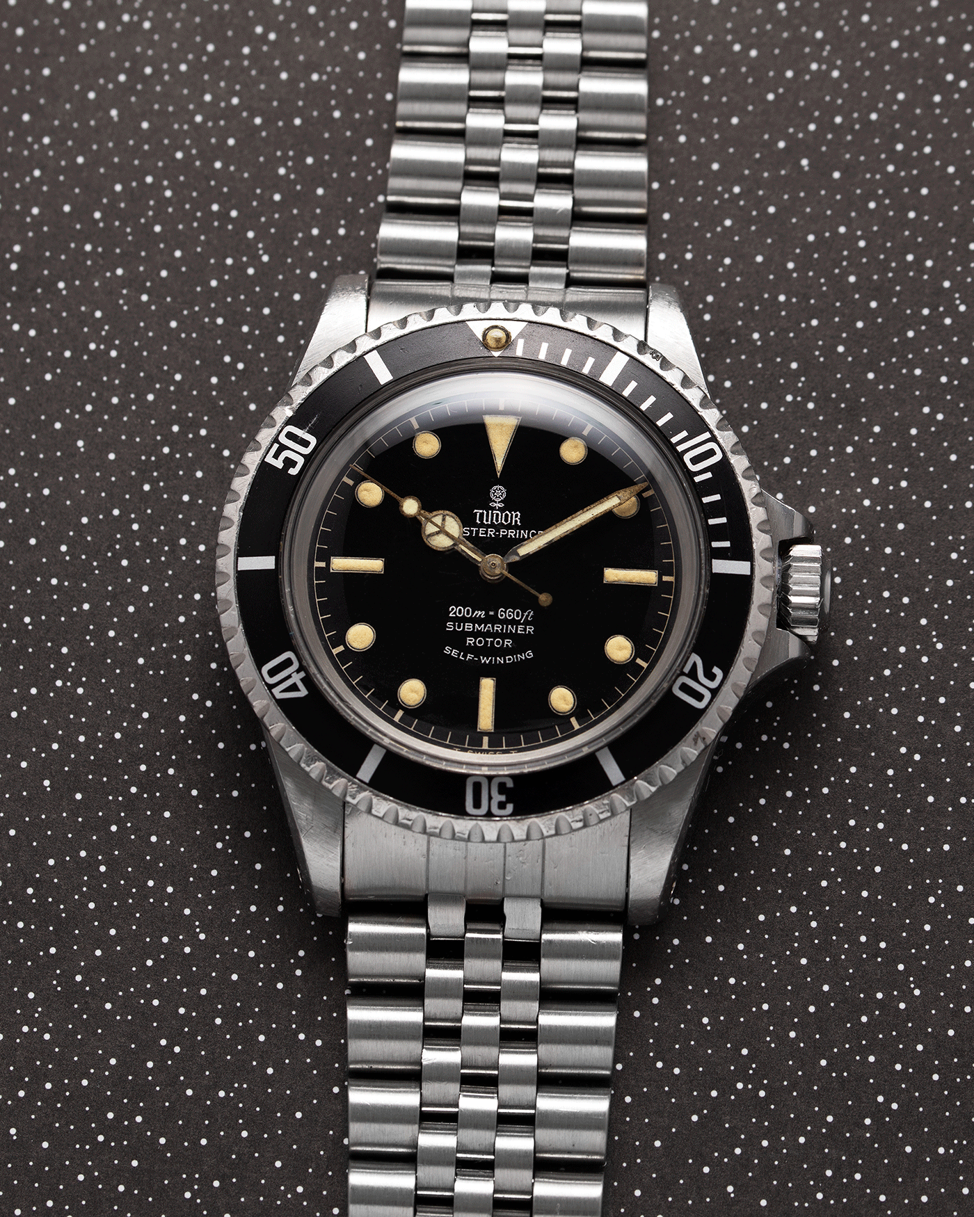 Brand: Tudor Year: 56XXXX Model: Submariner Reference Number: 7928 Serial Number: 1966 Material: Stainless Steel Movement: Cal. 390 Case Diameter: 39mm Lug Width: 20mm Bracelet: Rolex 62510H Jubilee with 555B End Links