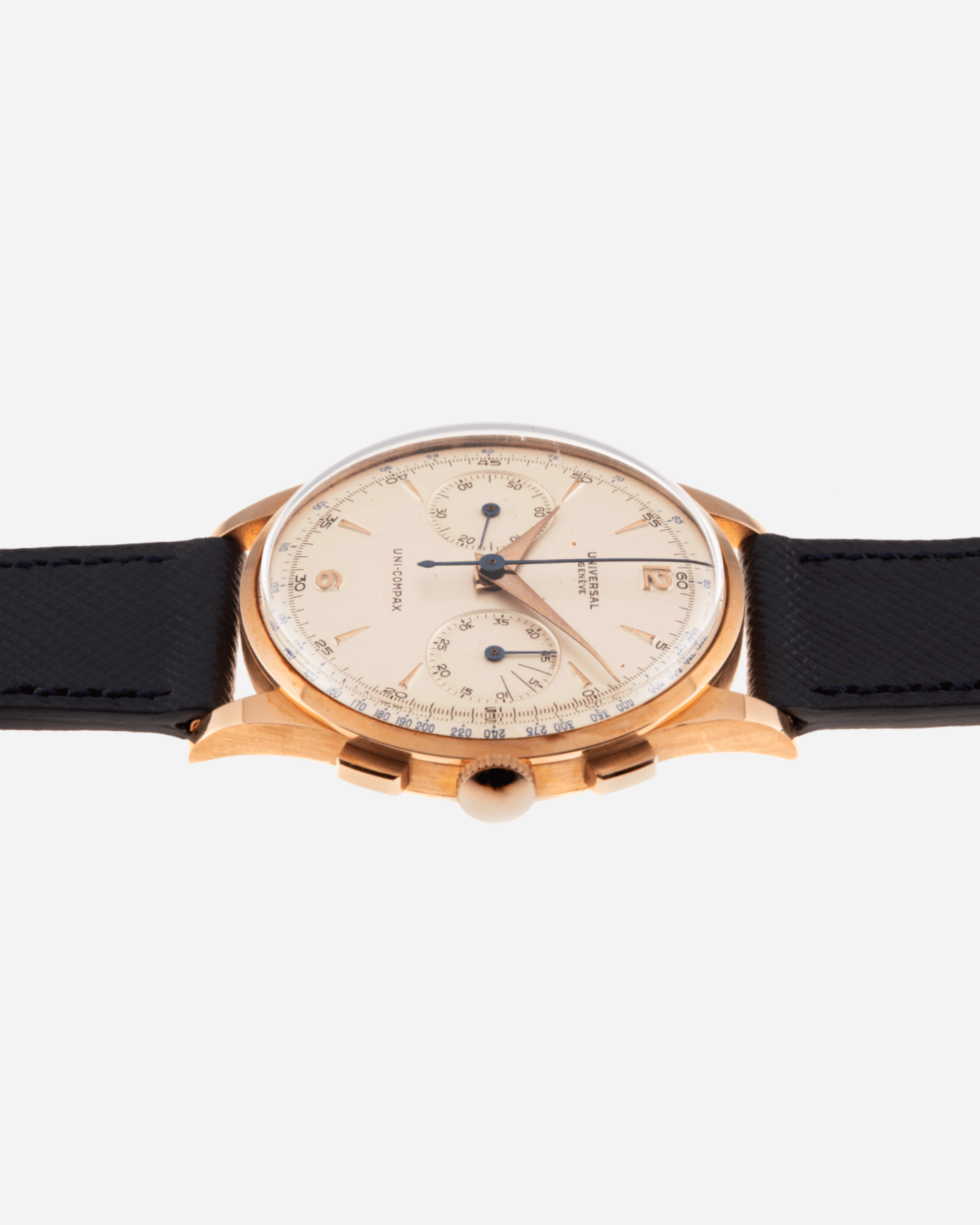 Brand: Universal Geneve Year: 1950’s Model: Uni-Compax Reference Number: 124103 Serial Number: 1550986 Material: 18k Pink Gold Movement: UG Cal. 285 Case Diameter: 37mm Lug Width: 20mm Bracelet/Strap: Molequin Navy Blue Textured Calf