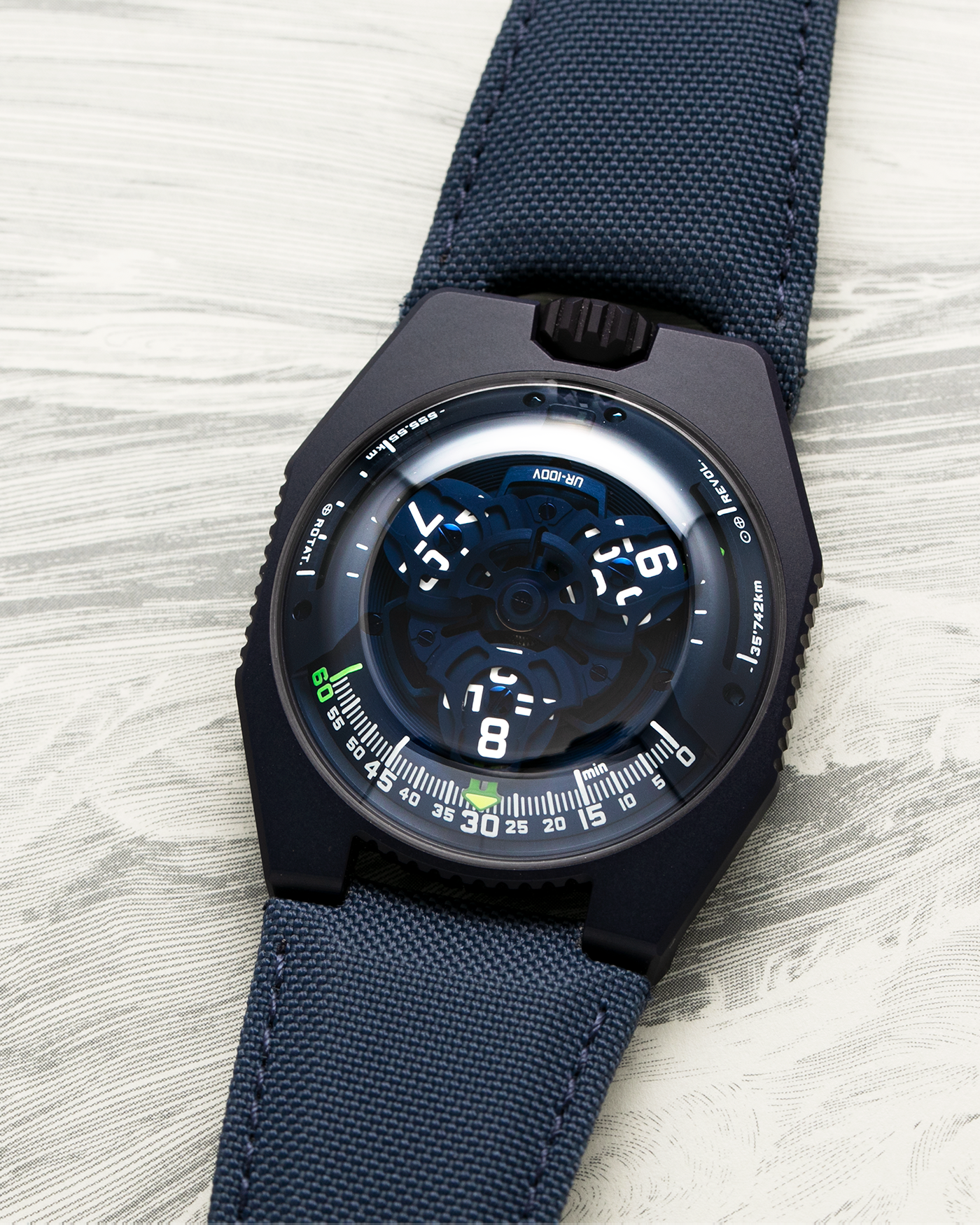 Brand: Urwerk Year: 2021 Model: UR100 Planet Blue Material: PVD Coated Titanium Movement: Urwerk Cal. 12.01 Case Diameter: 41mm Bracelet/Strap: Urwerk Army Blue Textile Strap