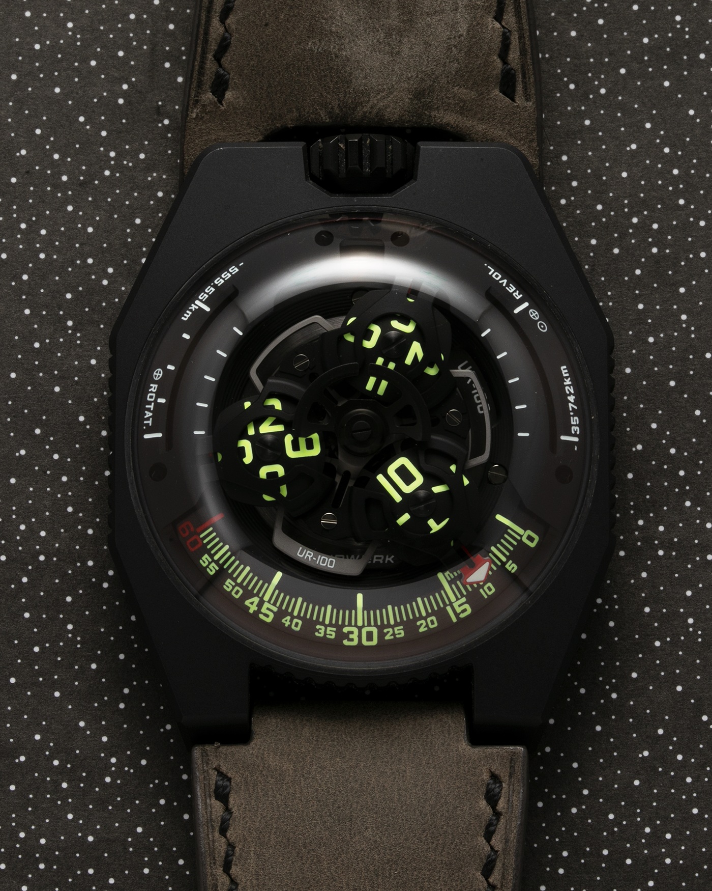 Brand: Urwerk Year: 2019 Model: UR100 Spacetime Black, Limited Edition of 25 pieces Material: Steel and Titanium, PVD Coated Movement: Urwerk Cal. 12.01, Self-Winding Case Dimensions: 41mm x 14mm Bracelet/Strap: Custom Moss Green Leather Strap with Signed Black DLC-Coated Titanium Tang Buckle, additional Urwerk Black Textile Strap 